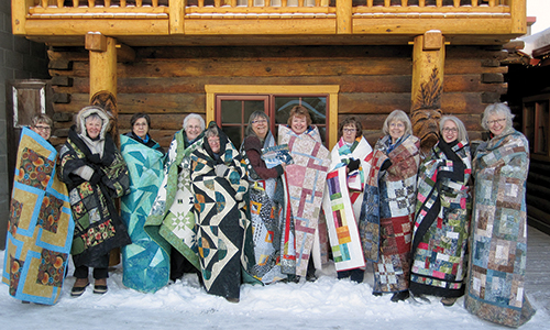 Bear's Paw Quilt staffers wrapped in their quilts